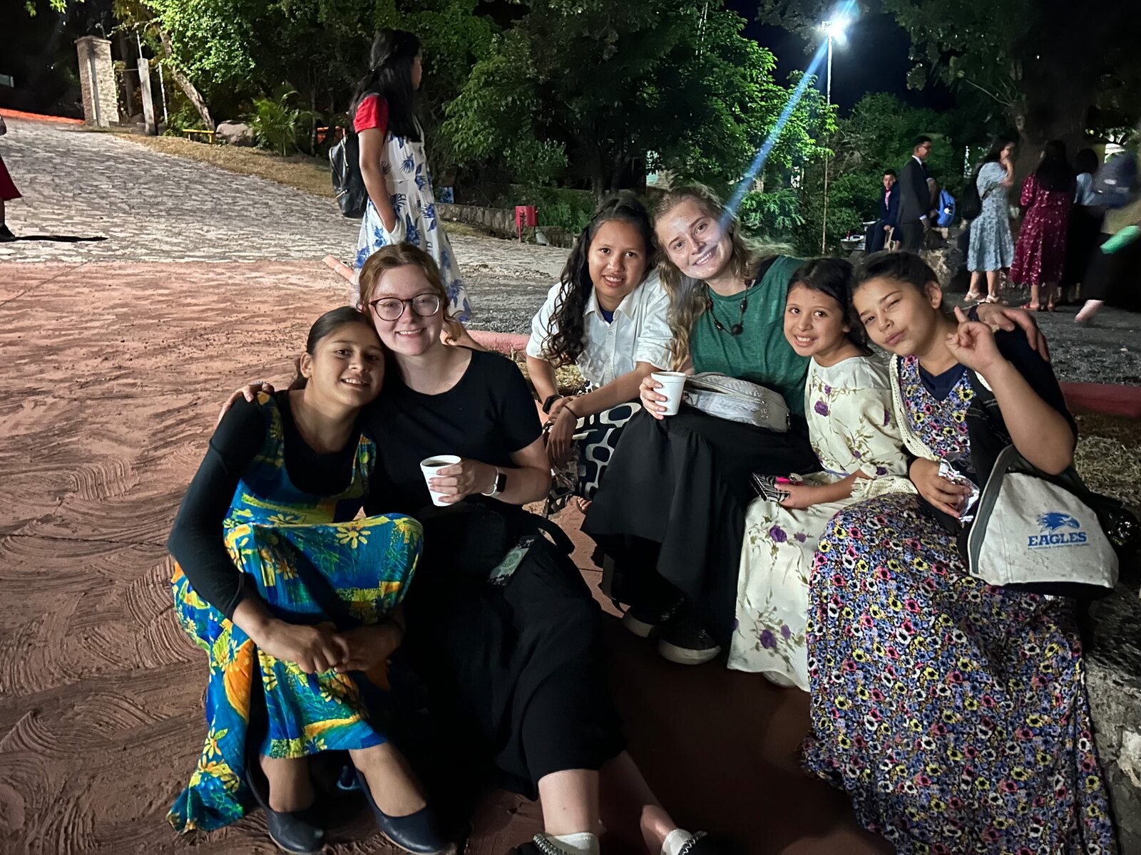 Ashley Robertson with a group of girls in the evening.